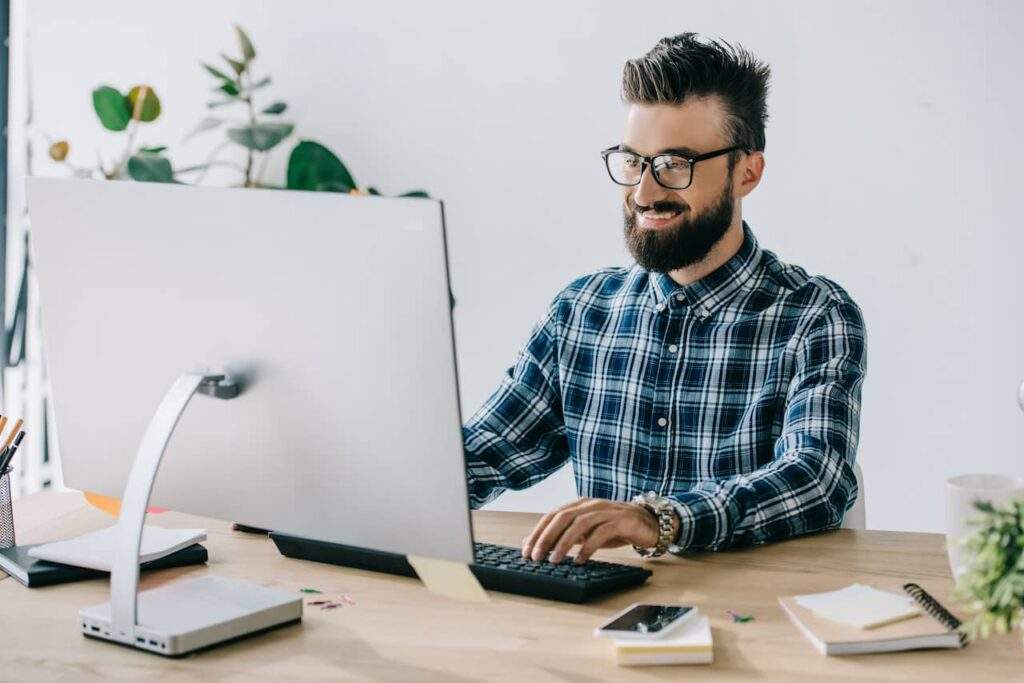Marketer monitoring SEO metrics on a computer.