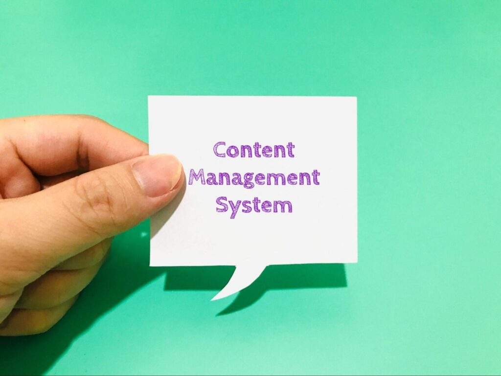 Hand holding not that says "Content Management System".